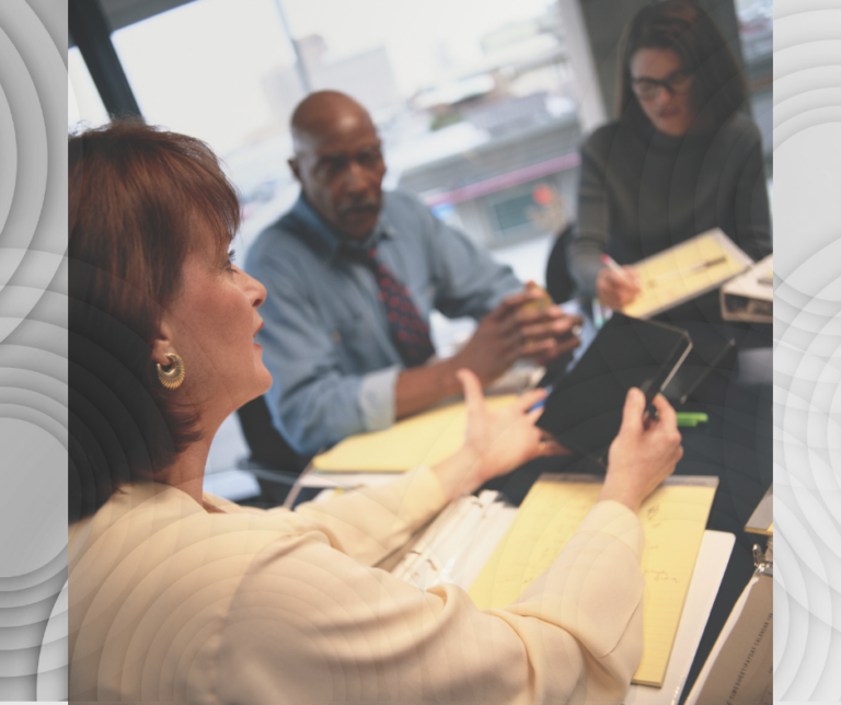 People sitting at a table having a meeting.